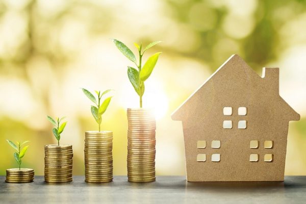 House Model and Golden Coins Stacks with blur Background.Savings Plans for Housing,Finance and Banking about House concept. House Model and Golden Coins Stacks with blur Background.Savings Plans for Housing,Finance and Banking about House concept.